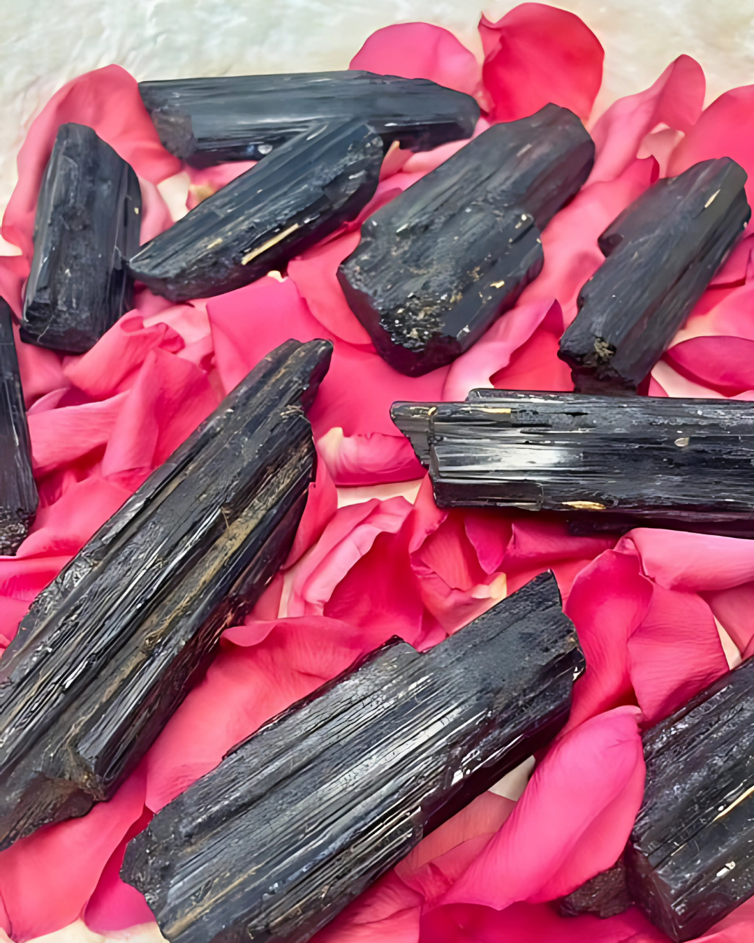Black crystals on pink rose petals
