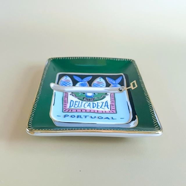 Small decorative tray with 'Delicadeza Portugal' branding on a light beige background