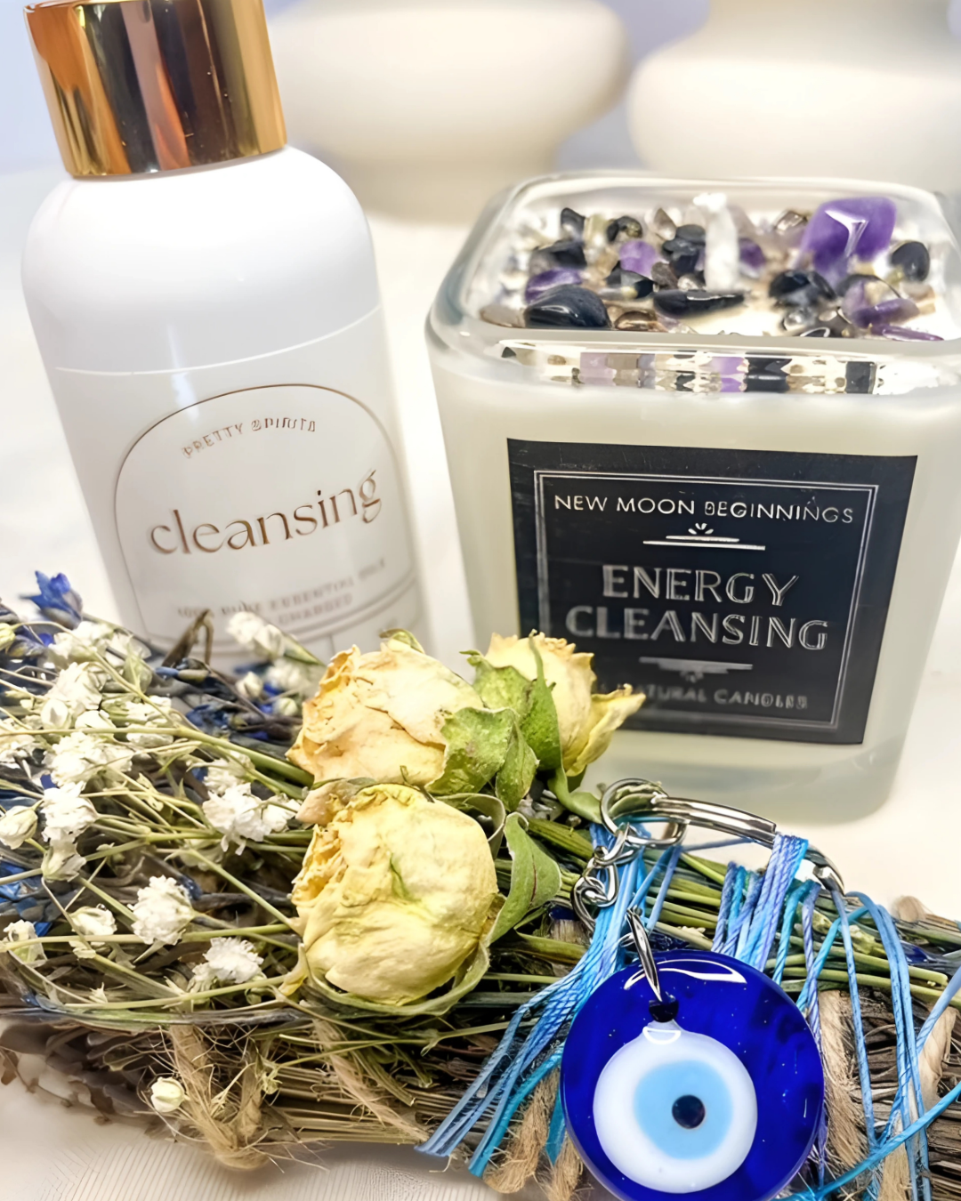 Cleansing products including a bottle, candle, and evil eye charm on a decorative background.