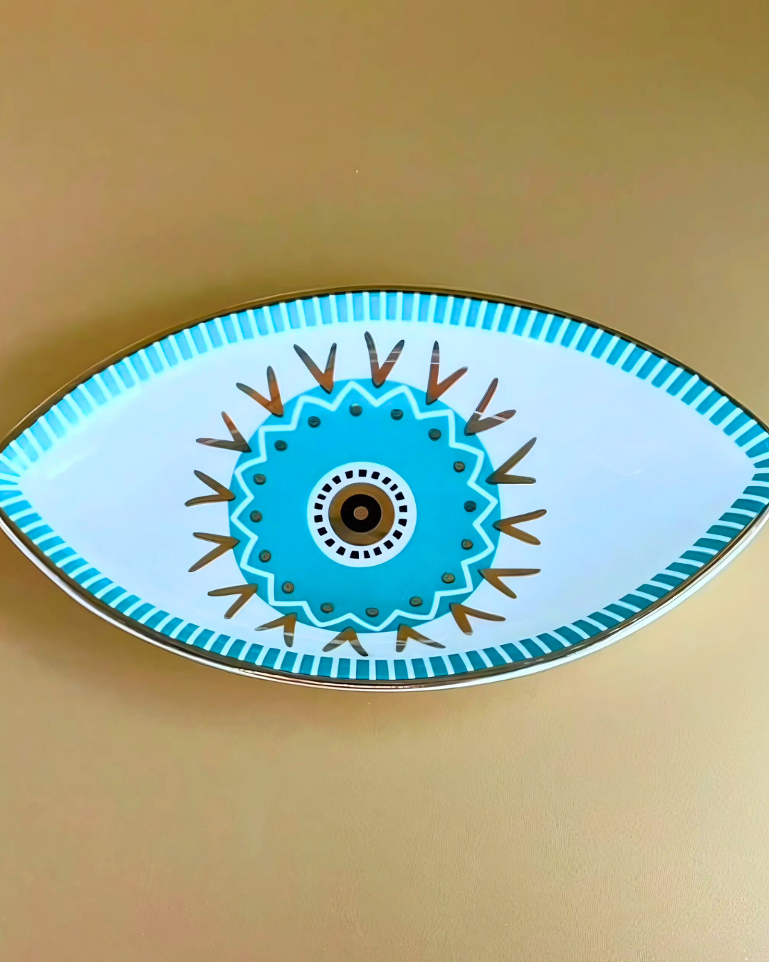 Decorative plate with eye design on a beige background