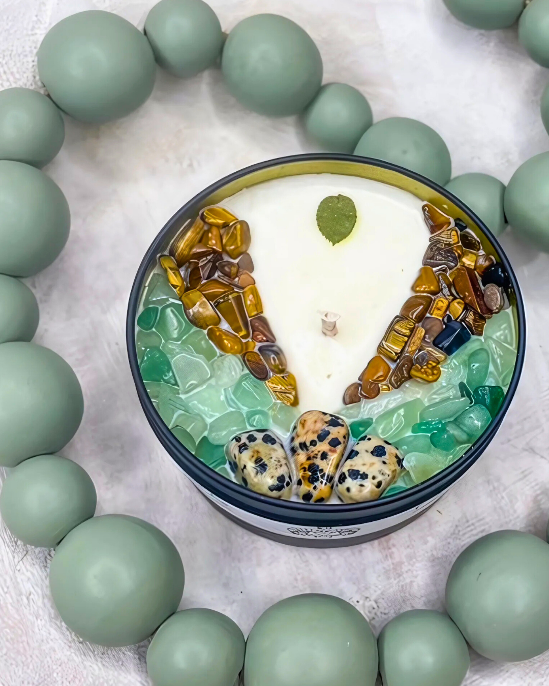 Decorative item with green beads and a central design on a light background