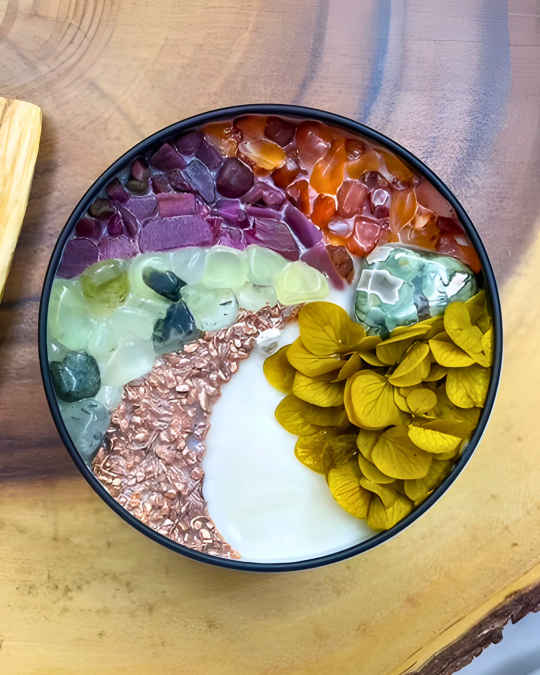 Colorful dessert with layered fruits and a spoon on a wooden surface