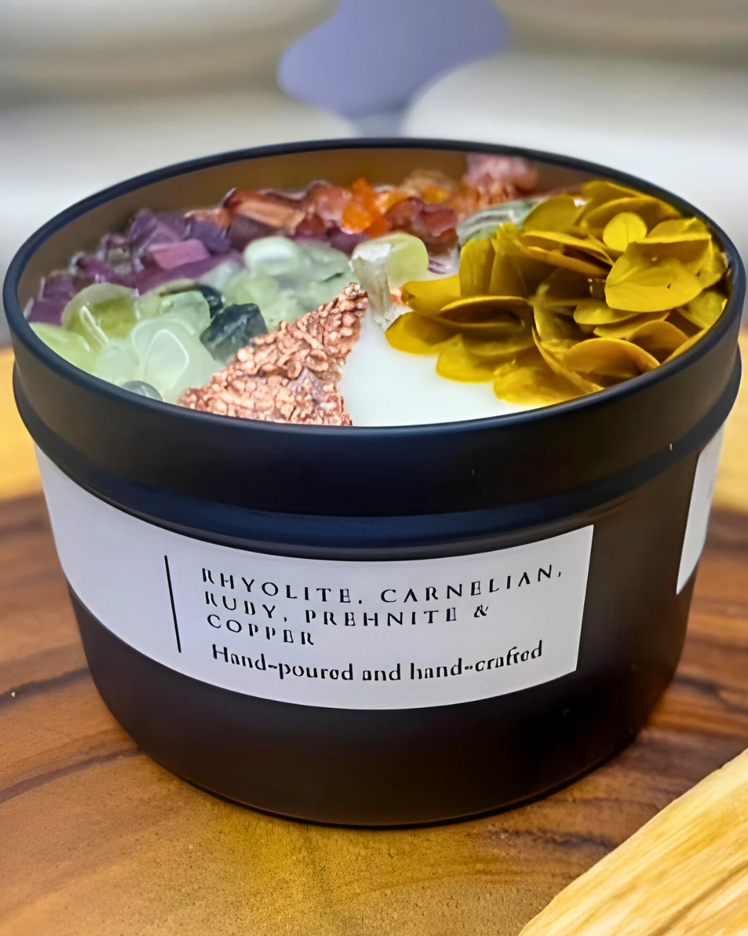 Decorative bowl with colorful stones and a label on a wooden surface