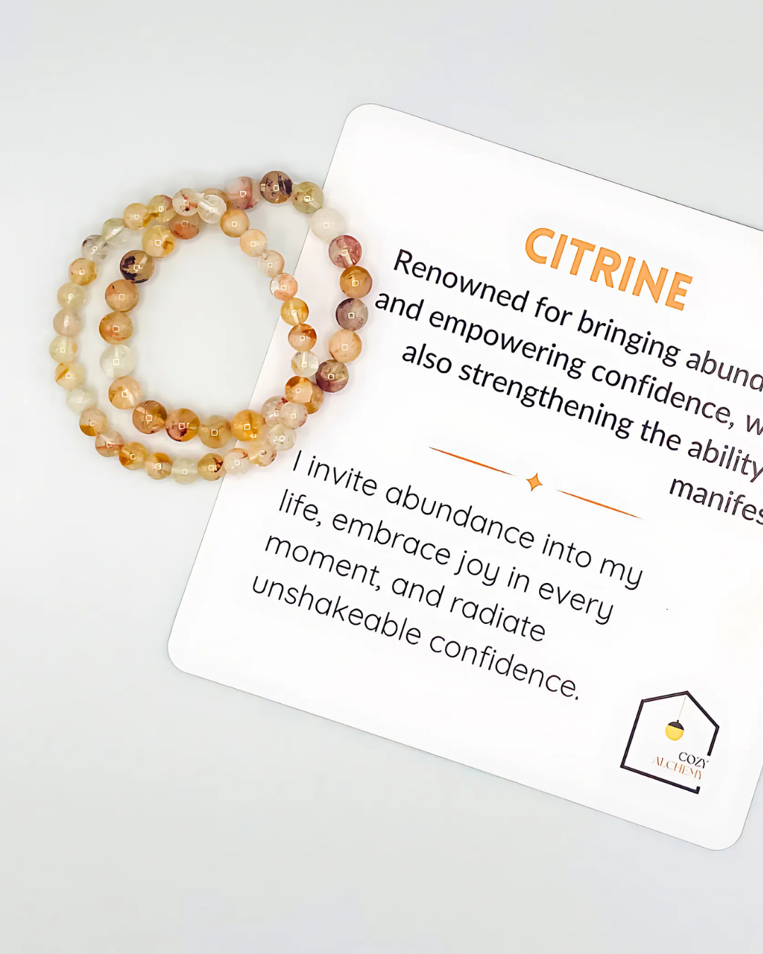Citrine bracelet with a card explaining its properties on a white background