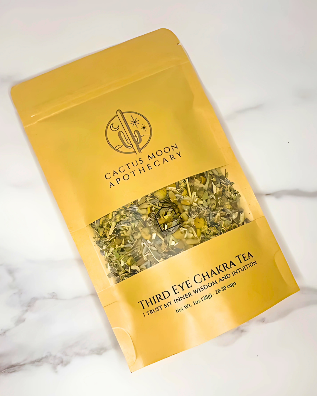 Yellow package of Third Eye Chakra Tea from Cactus Moon Apothecary on a marble surface