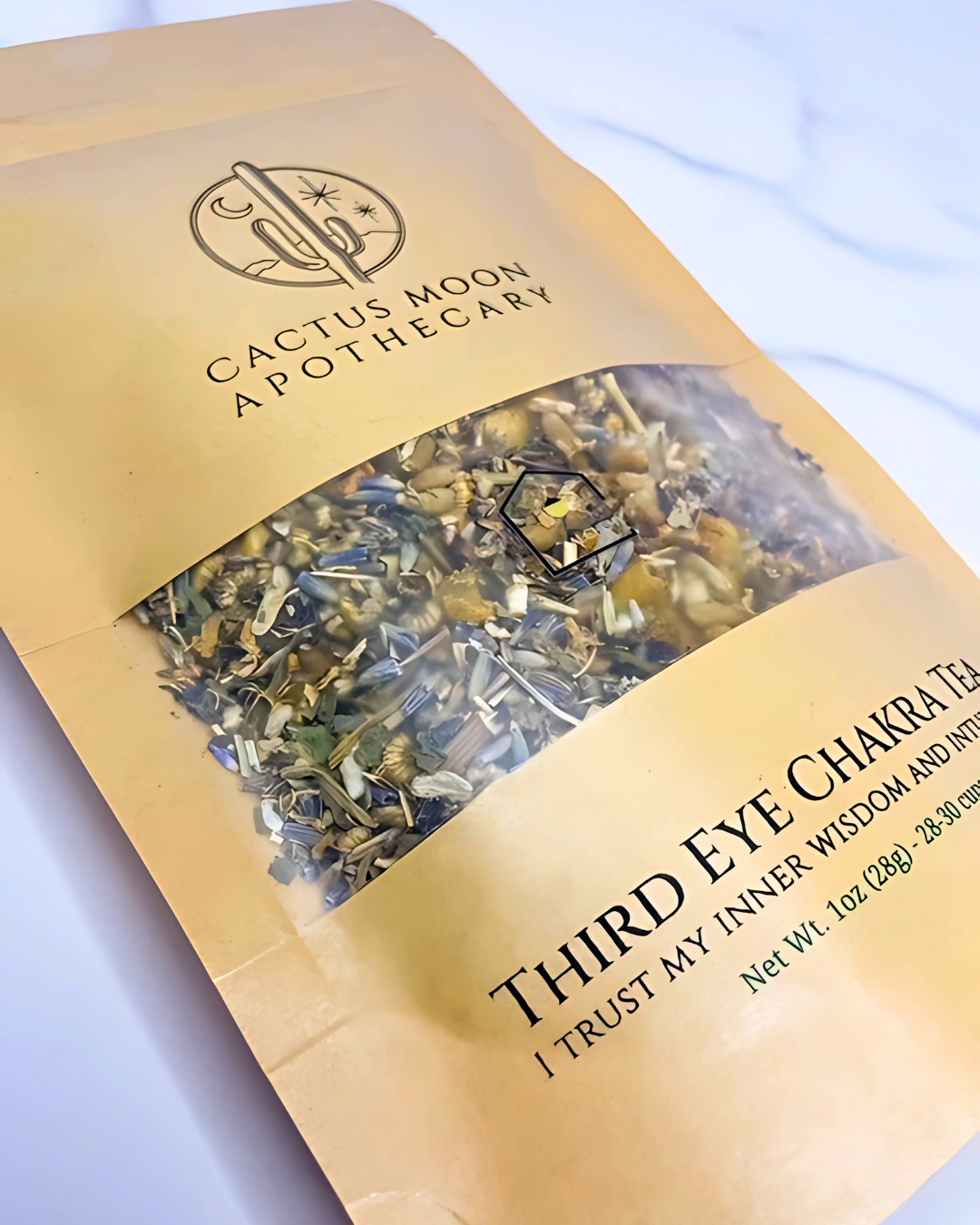 Tea package from Cactus Moon Apothecary with visible tea leaves inside