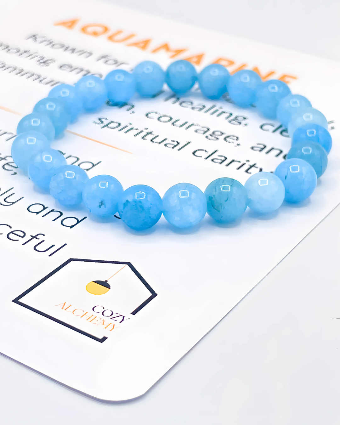 Blue beaded bracelet on a piece of paper with text and a logo.