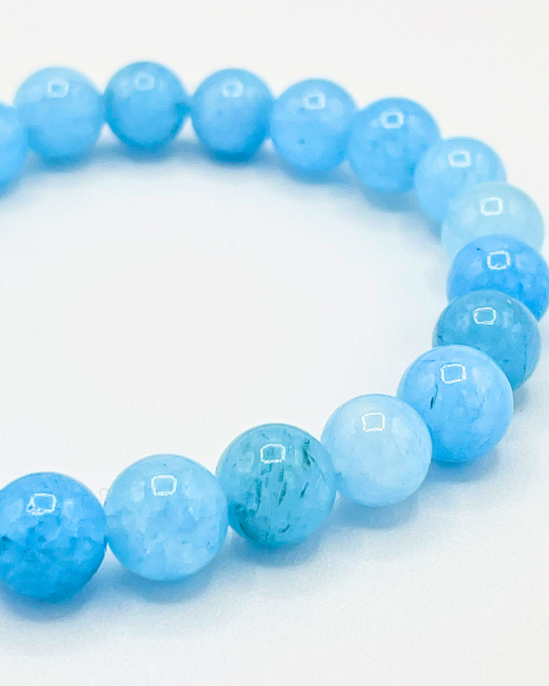Blue beaded bracelet on a white background
