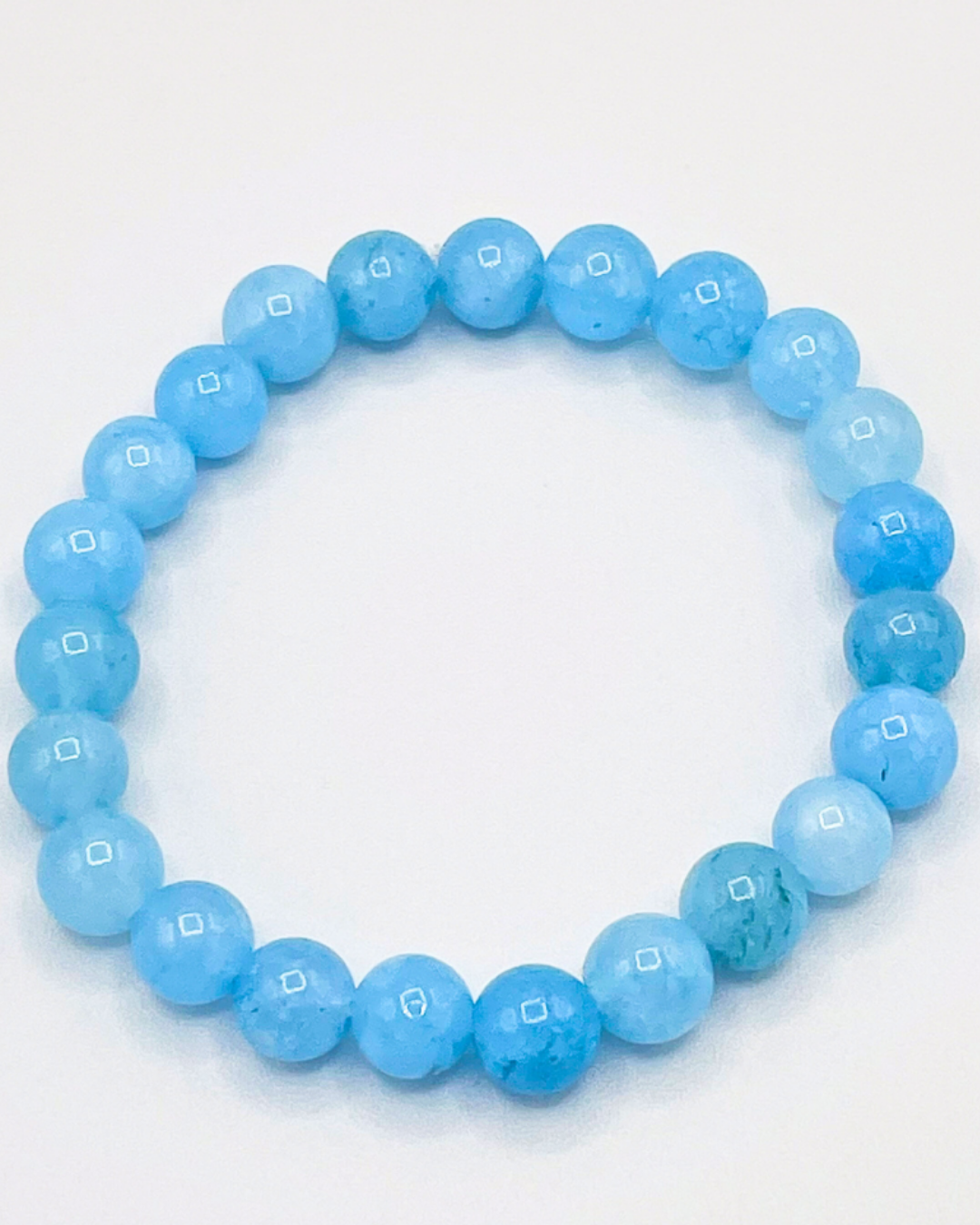 Blue beaded bracelet on a white background