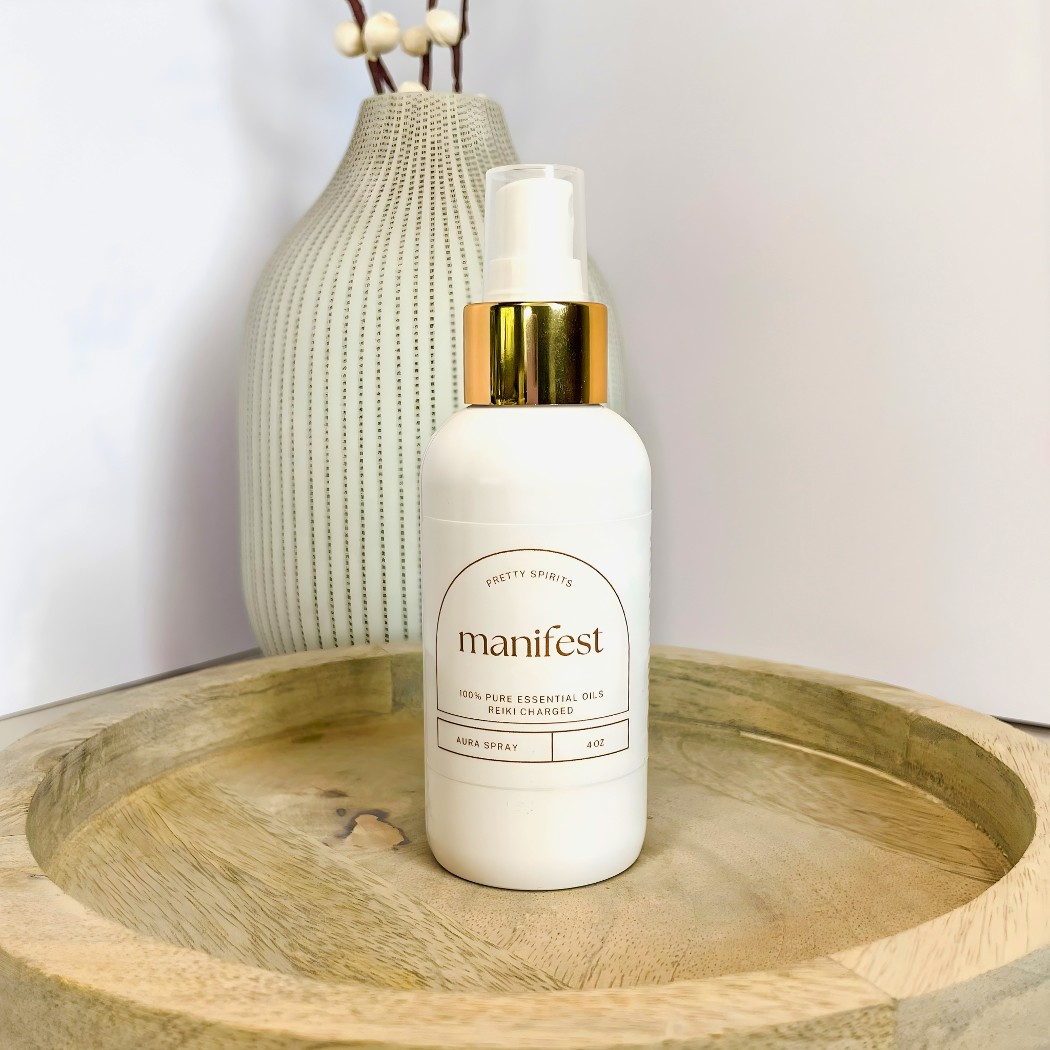 Manifest bottle on a wooden tray with a vase in the background