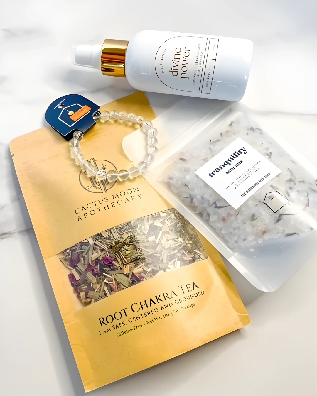 Collection of wellness products including a bottle, bracelet, and tea package on a light background