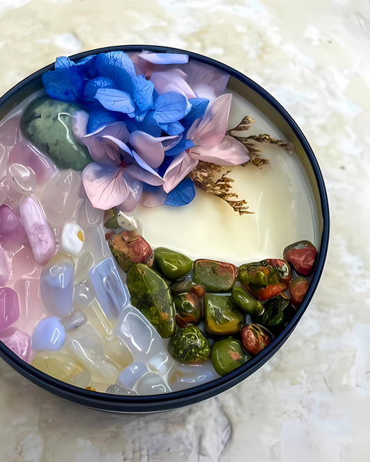 Decorative bowl with colorful stones and flowers on a textured surface