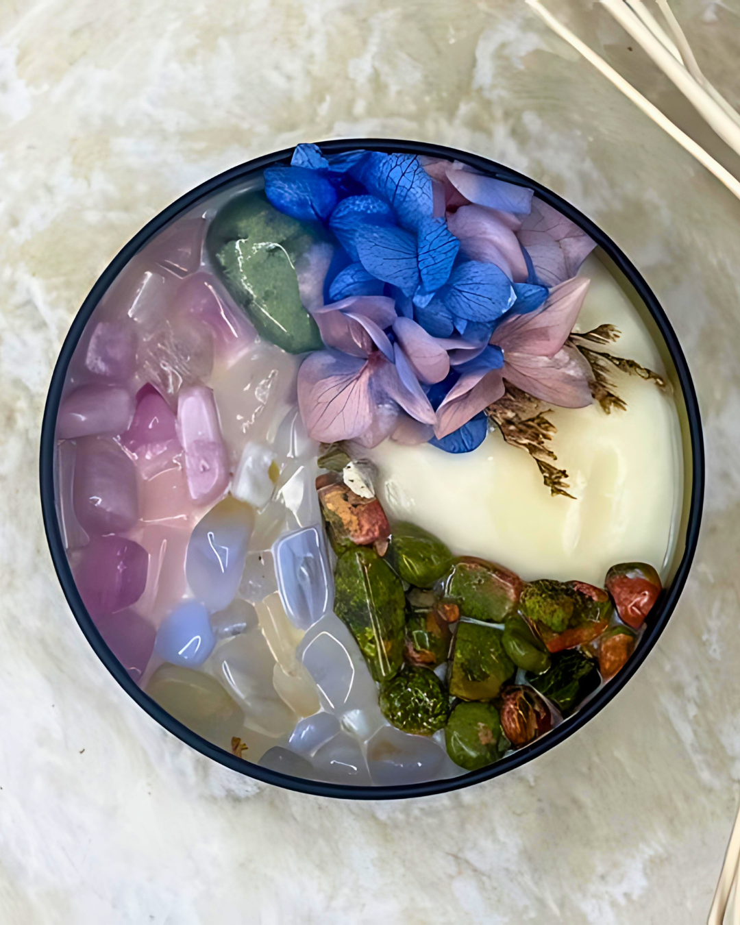 Decorative bowl with colorful jelly-like substances on a marble surface