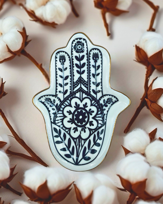 Decorative Hamsa hand pin on a background of cotton and branches