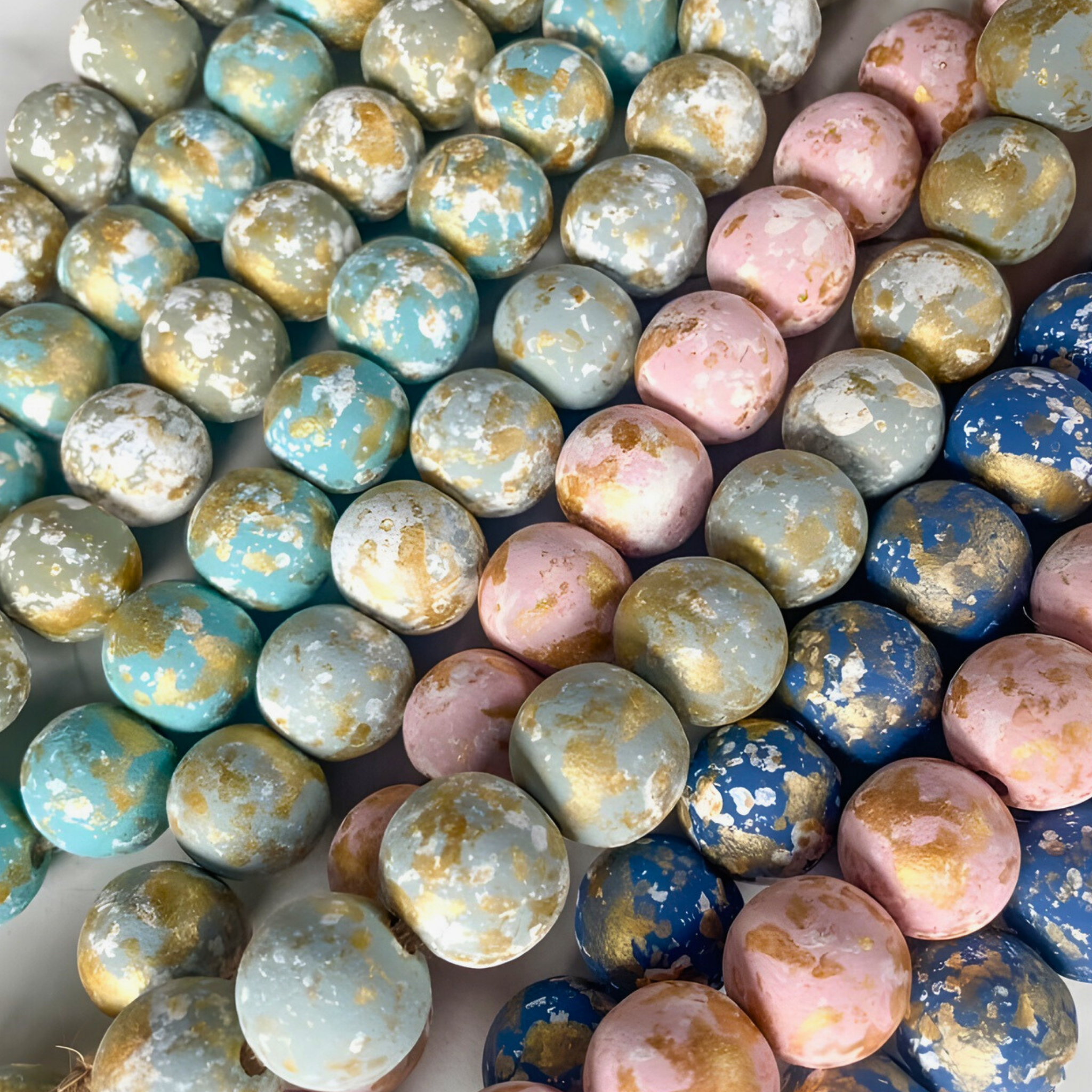 Colorful marbled candies in various shades of blue, pink, and gold.
