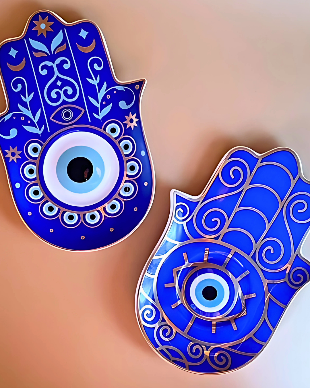 Decorative blue Hamsa hands with intricate designs on a gradient background