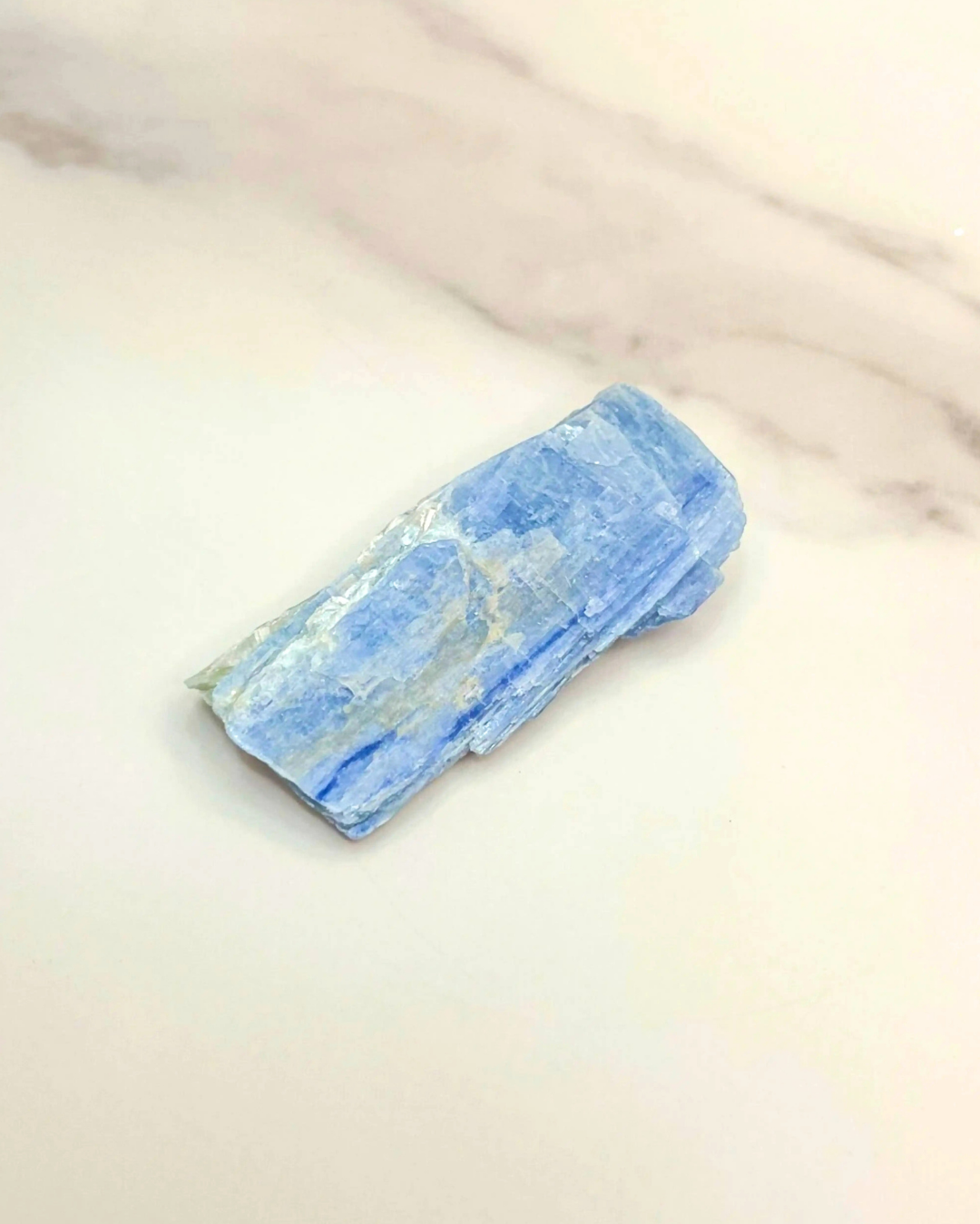 Blue crystal on a light beige background