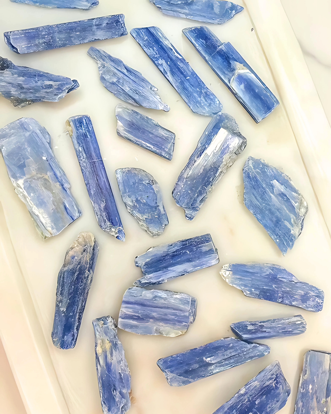 Blue crystal pieces on a light beige surface