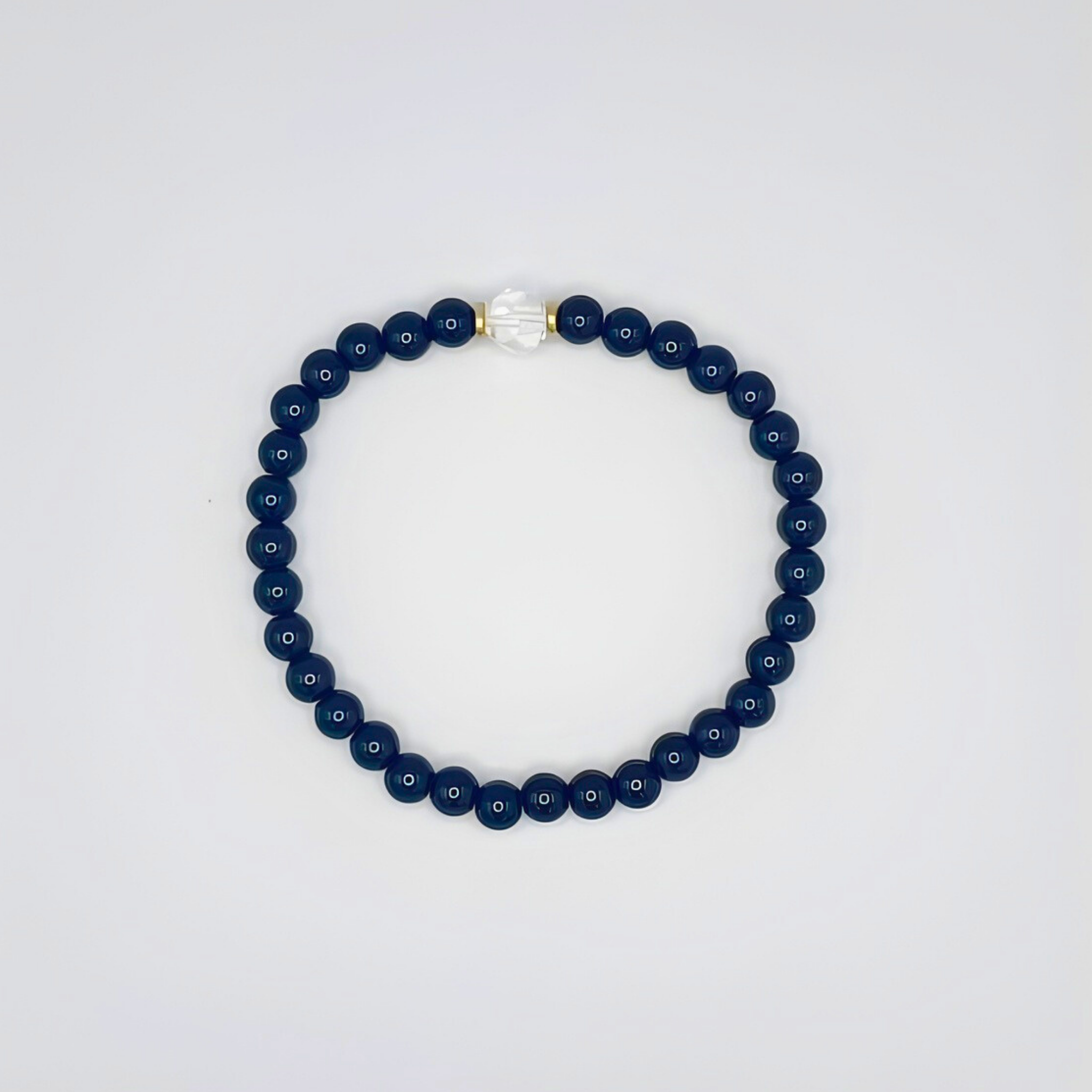 Navy blue beaded bracelet on a light gray background