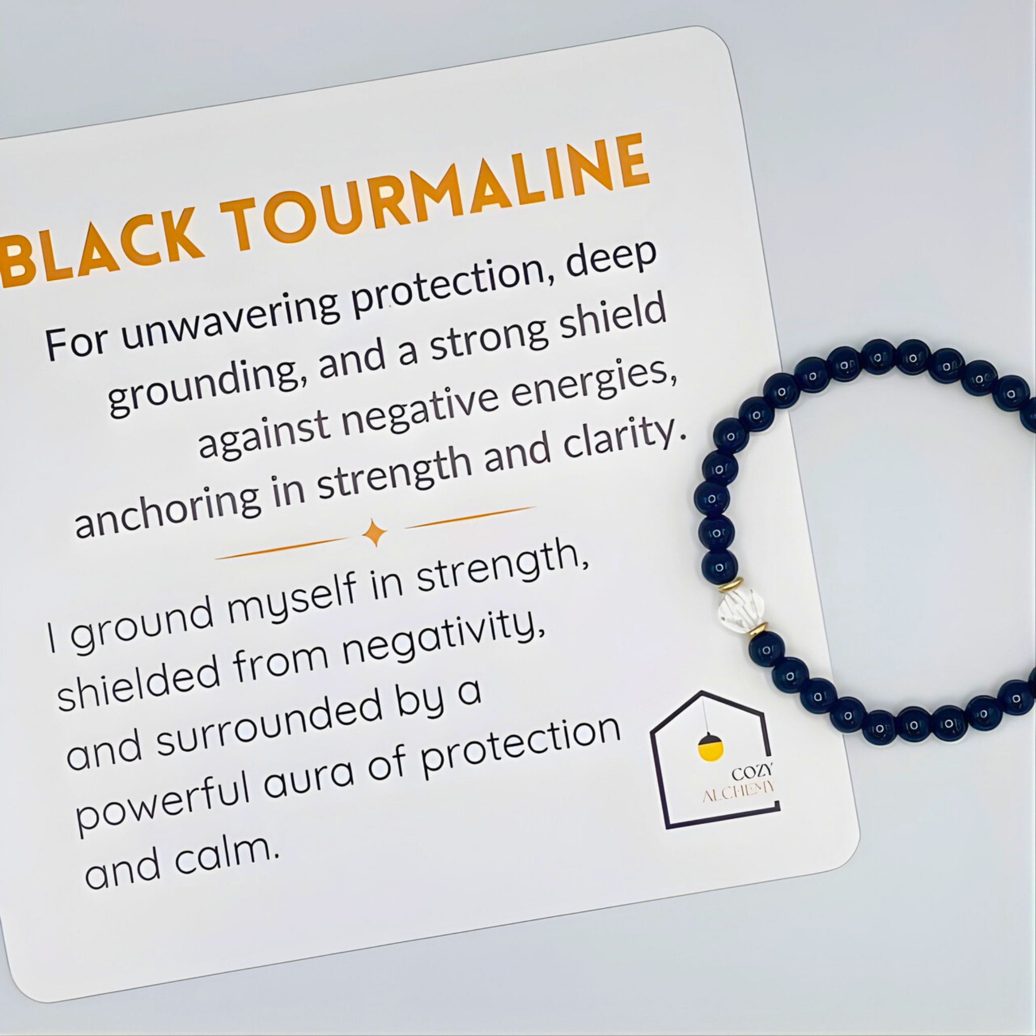 Black tourmaline bracelet on a card with text about its properties