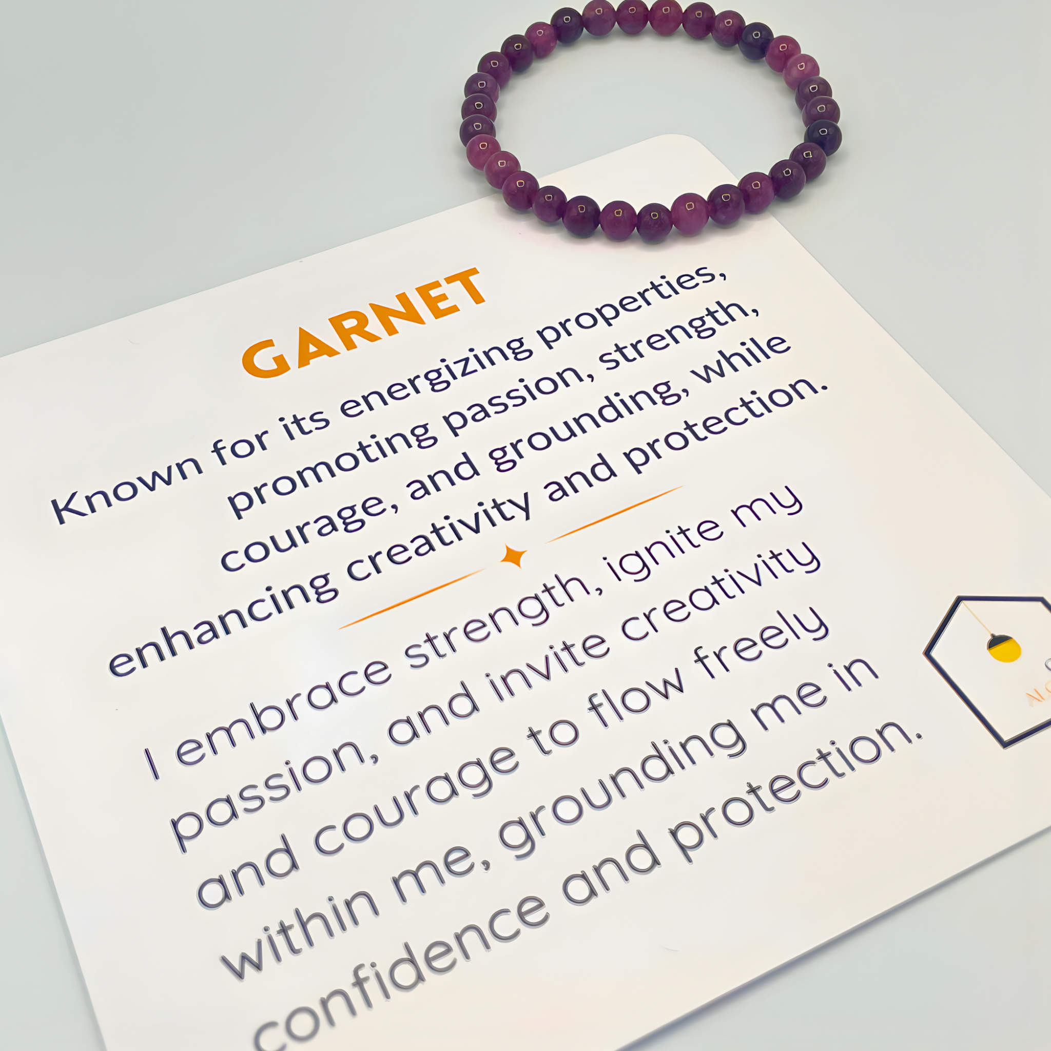 Garnet bracelet on a card with information about garnet properties