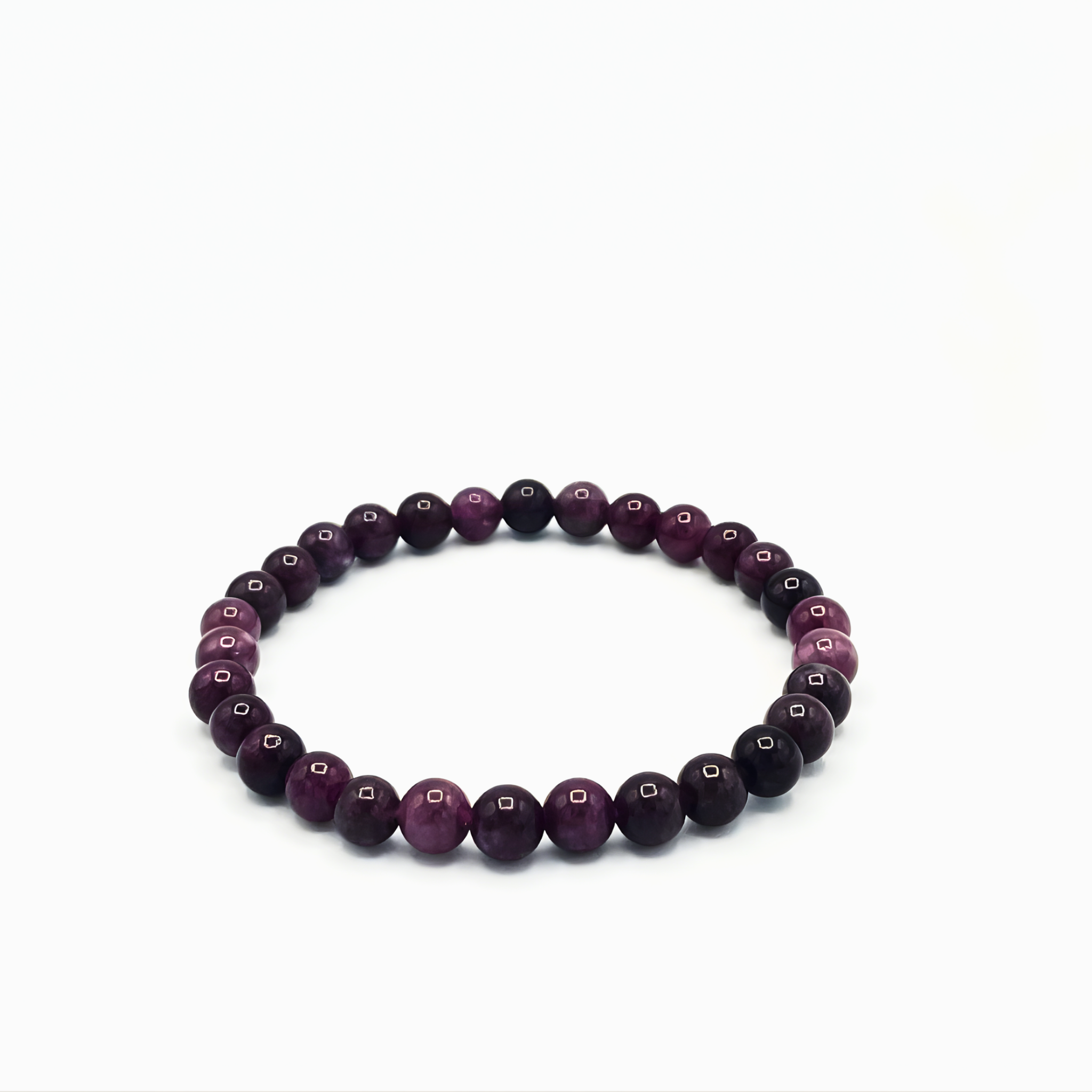 Beaded bracelet with purple and black beads on a white background