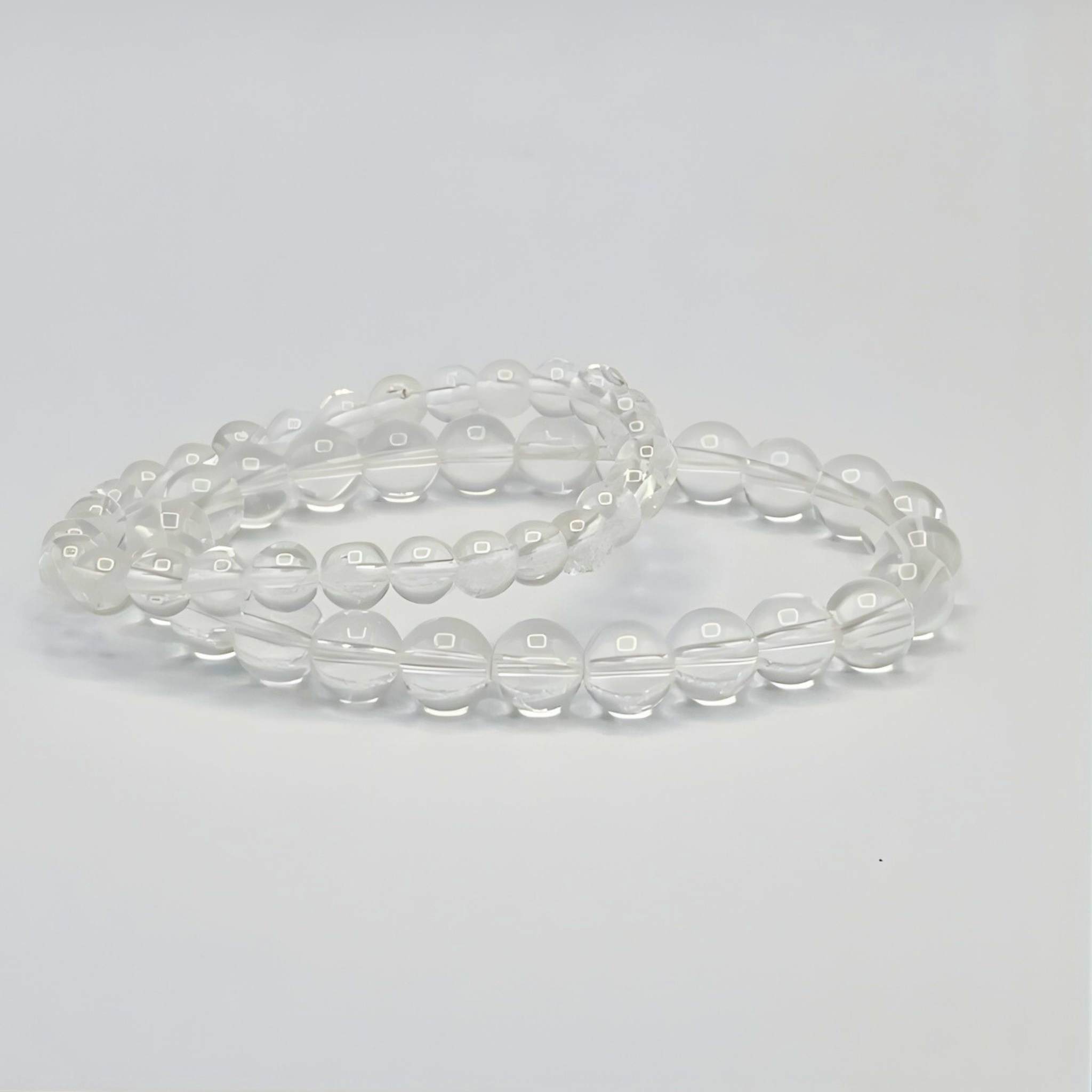Clear beaded bracelet on a light gray background