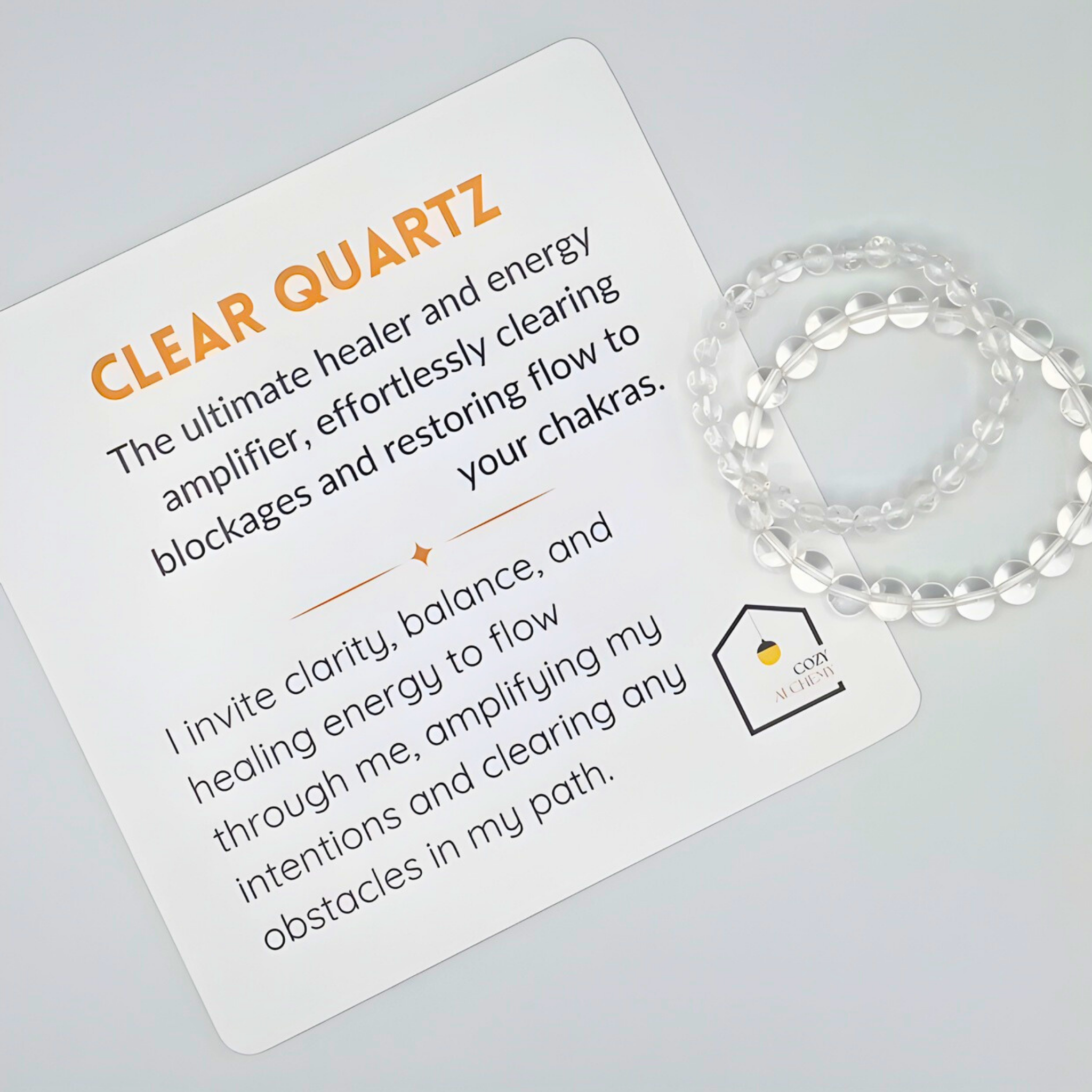 Clear quartz bracelet with descriptive card on a light gray background