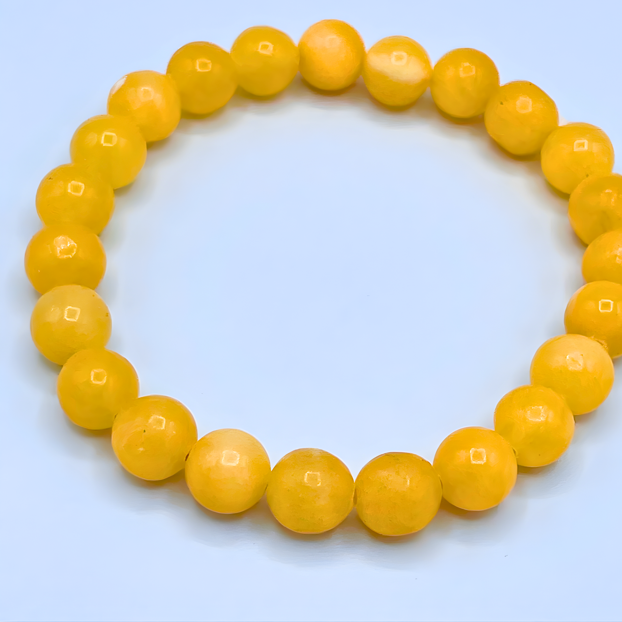 Yellow beaded bracelet on a light blue background
