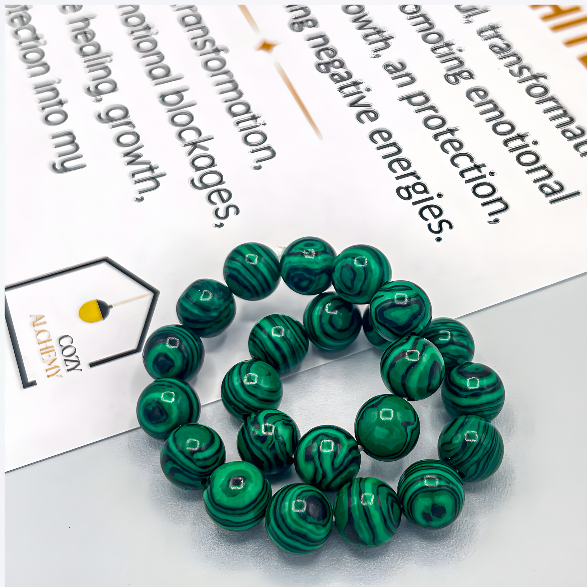 Green marbled beads on a white surface with text in the background