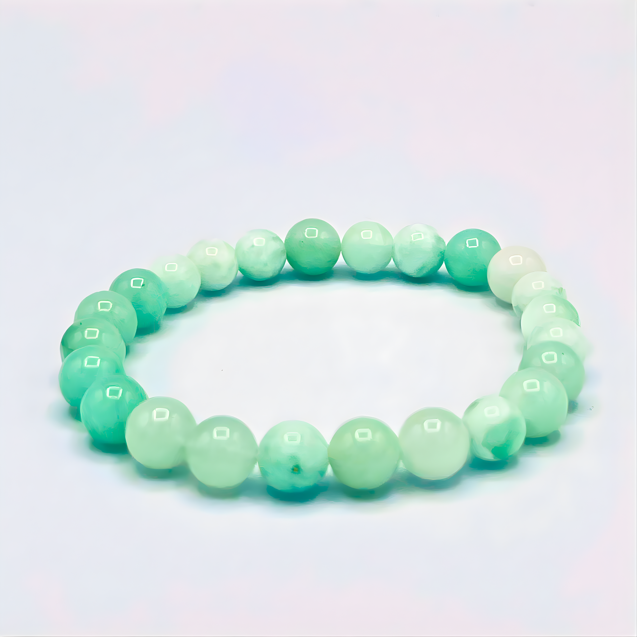 Green beaded bracelet on a light blue background