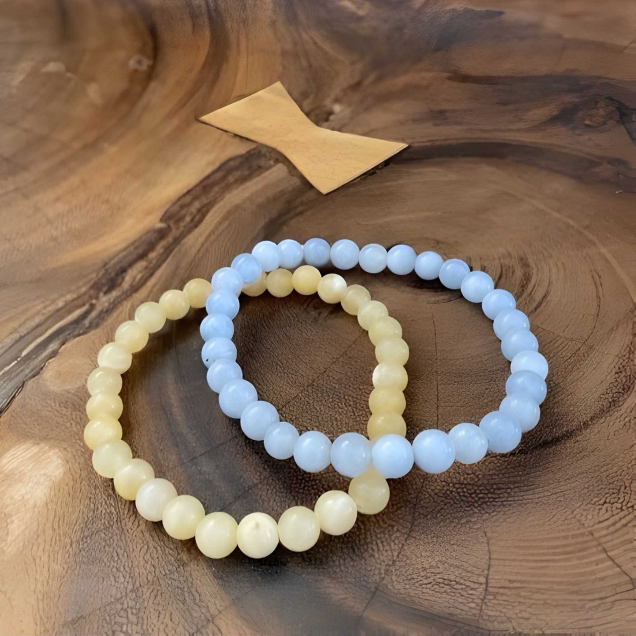 Two beaded bracelets on a wooden surface