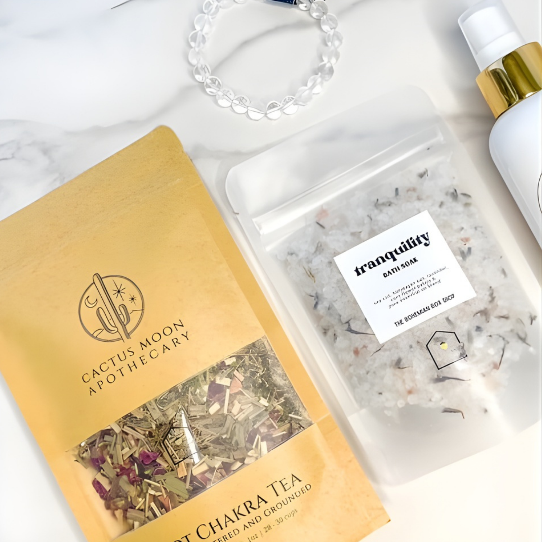 Cactus Moon Apothecary packaging with a jar of bath salts and a bottle on a marble surface.