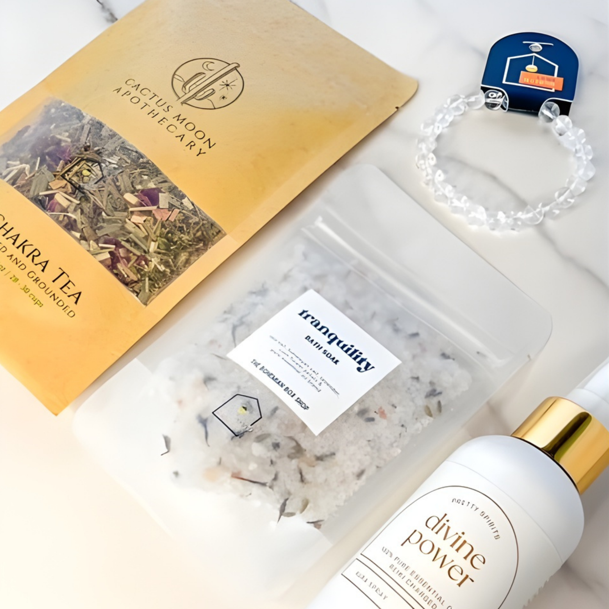Cactus Moon Apothecary products including Chakra Tea, Tranquility Bath Salts, and Divine Power oil on a white background.