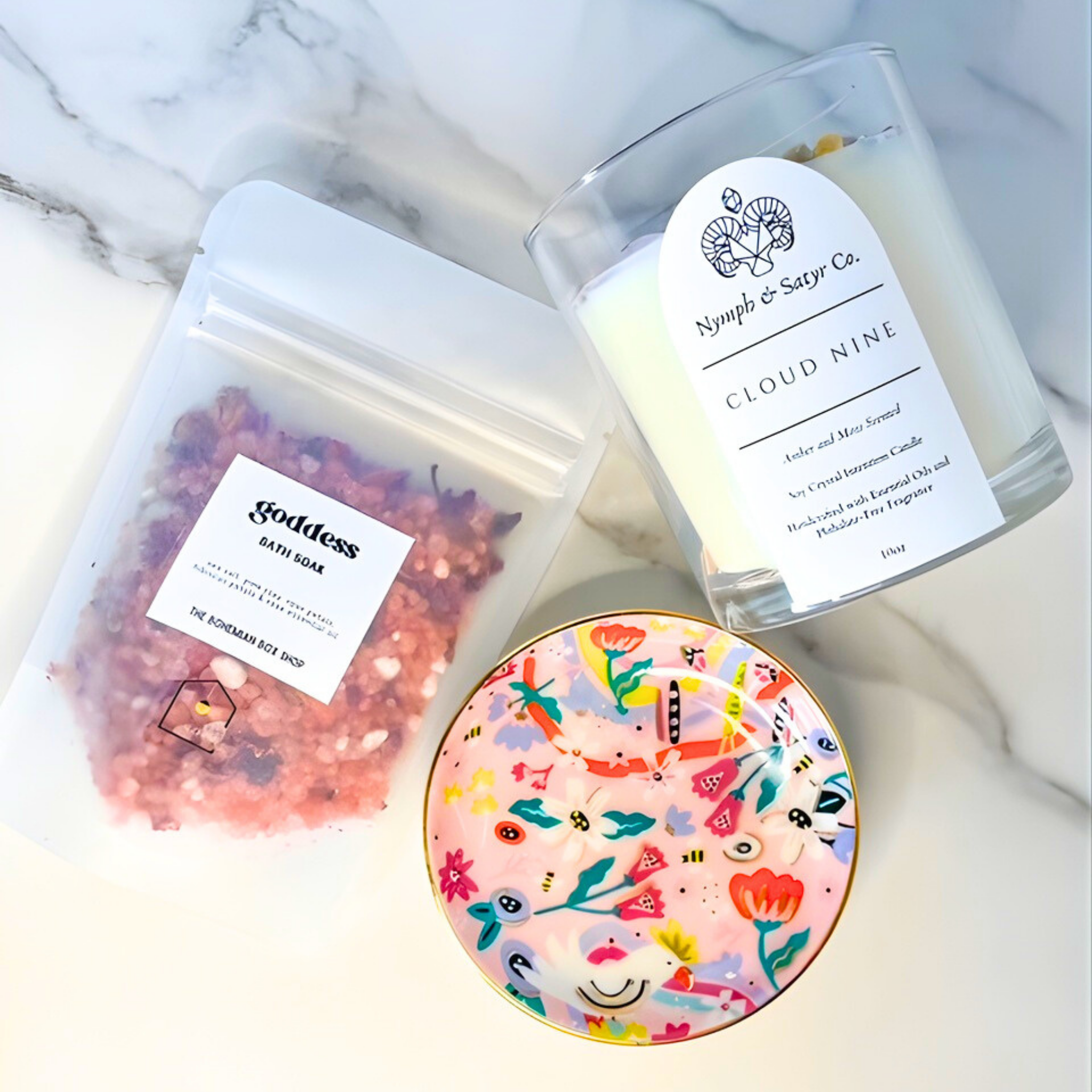 Bath soap, candle, and decorative plate on a marble surface