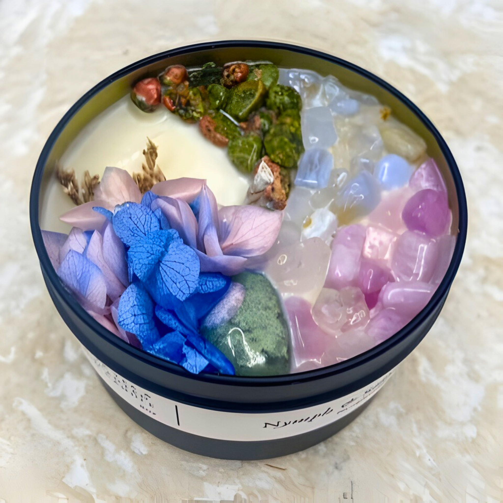 Candle with colorful butterfly decorations in a container