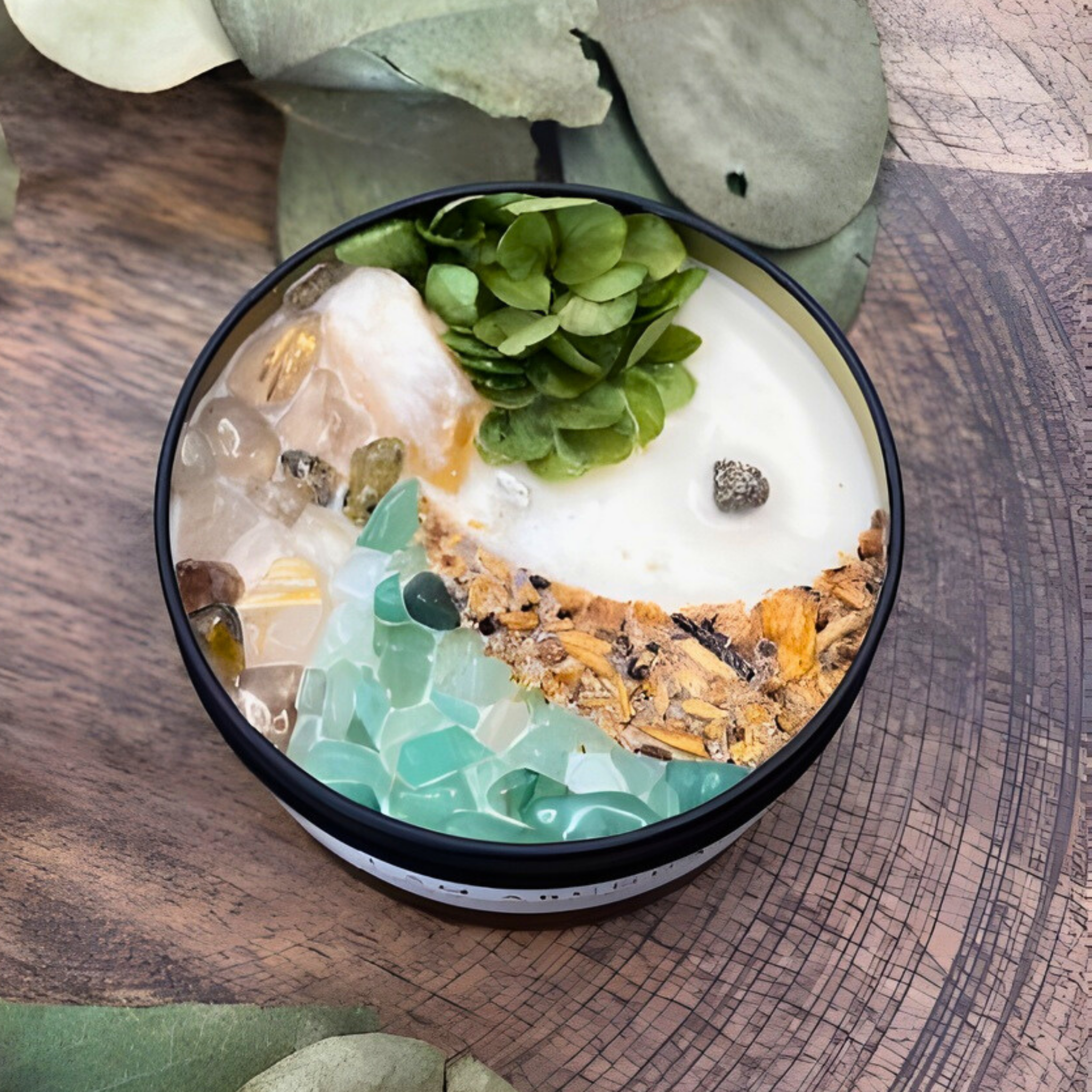 Decorative bowl with pebbles, stones, and a small plant on a wooden surface