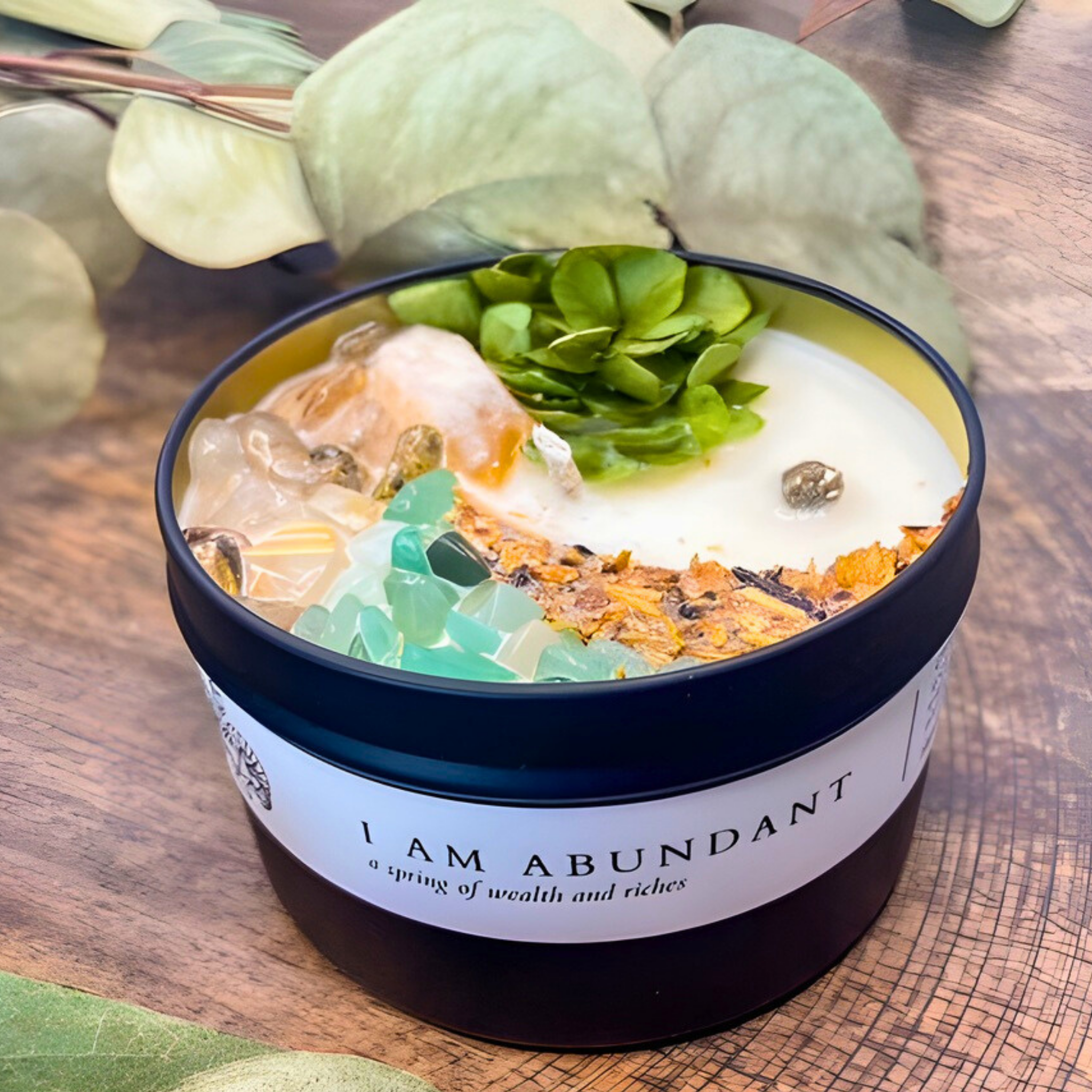 Decorative bowl with a label 'I AM ABUNDANT' on a wooden surface.