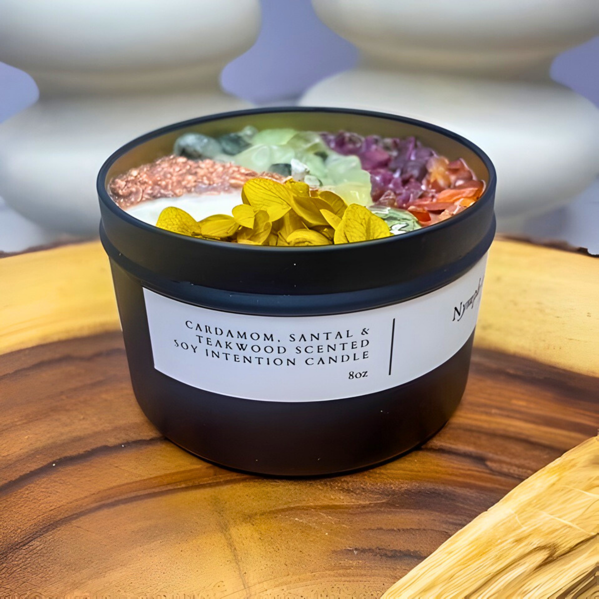 Scented candle with decorative elements on a wooden surface