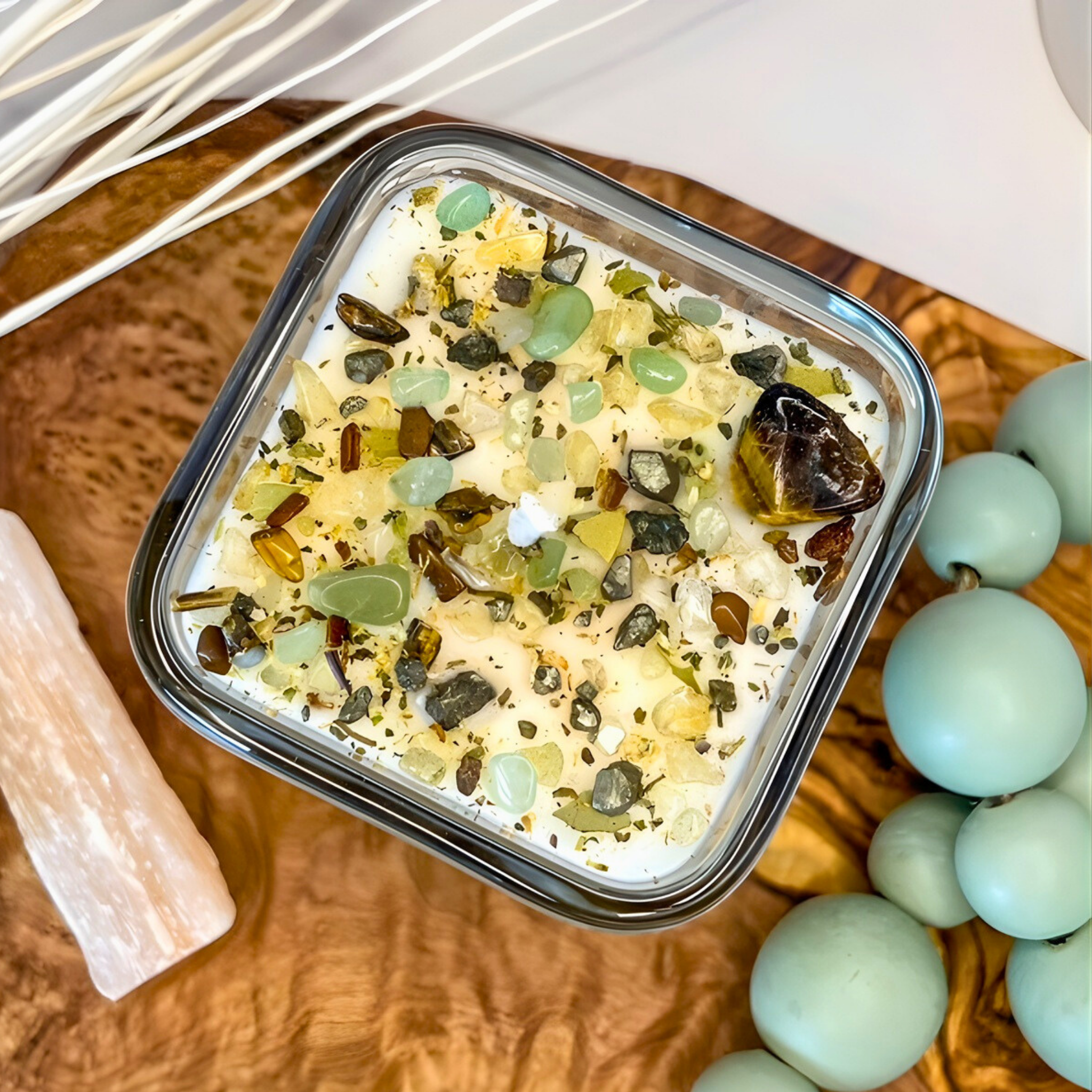 Container of dessert with decorative stones on a wooden board with decorative stones and sticks.