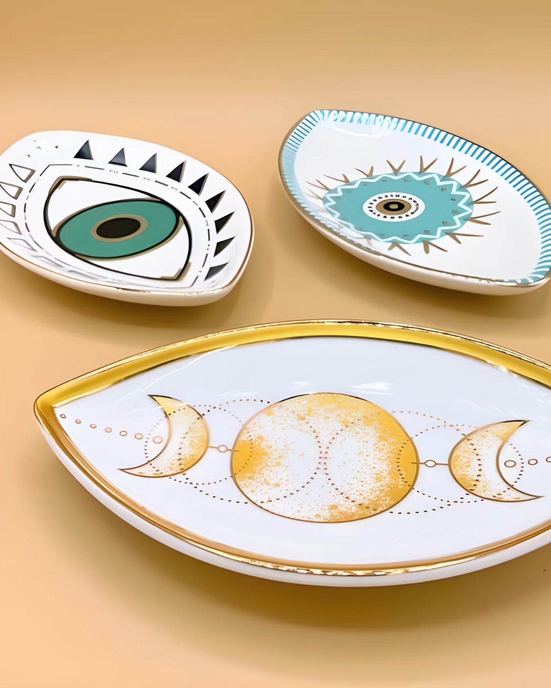 Three decorative ceramic plates with unique designs on a beige background