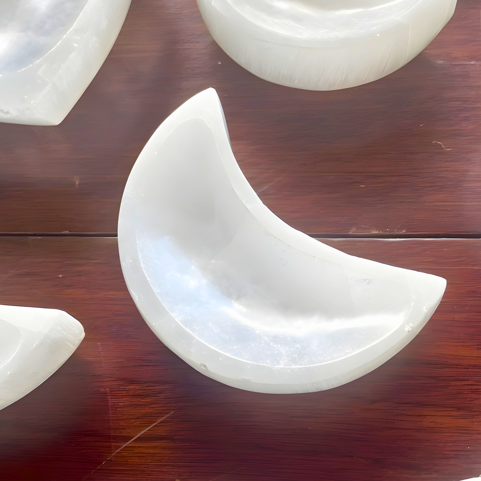 White ceramic crescent moon dish on a wooden surface