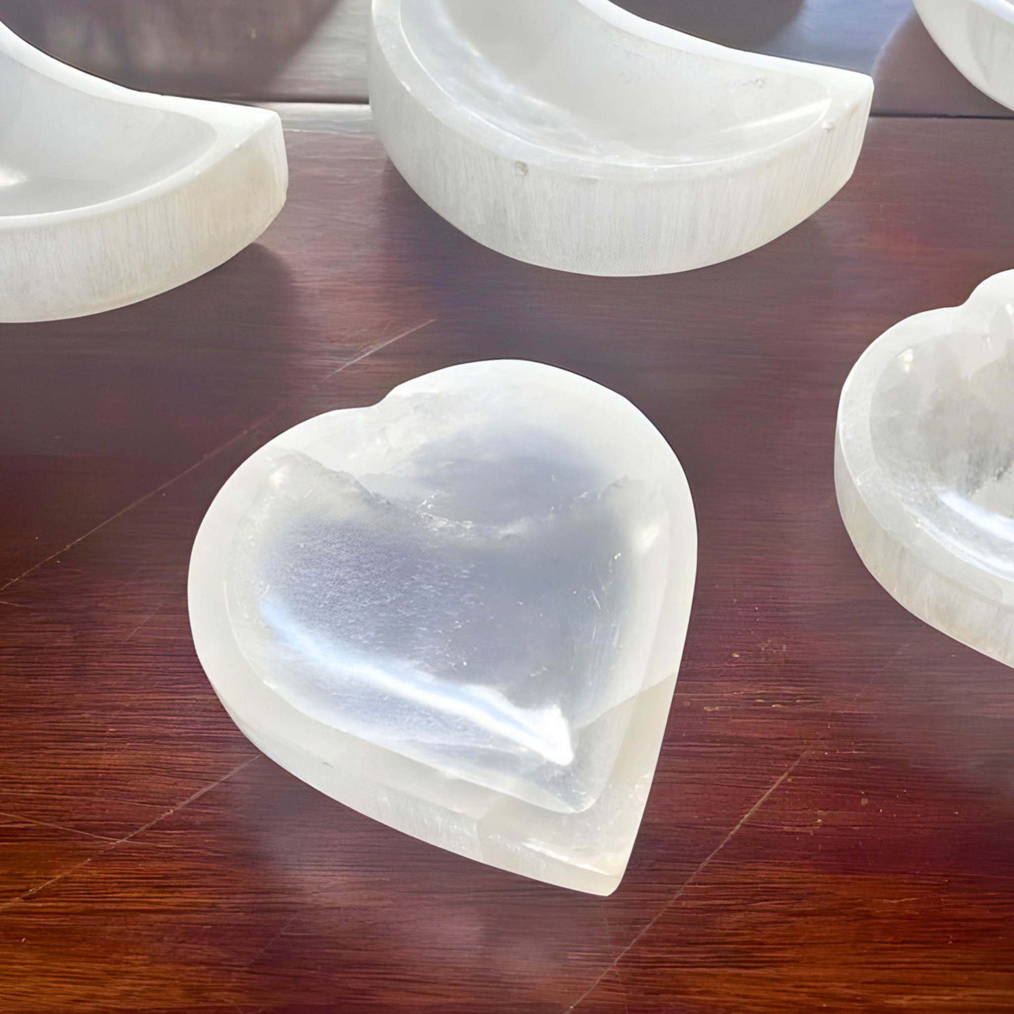 Heart-shaped white stone on a wooden surface