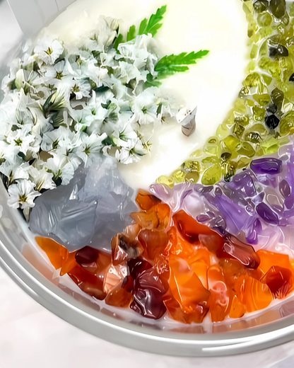 Colorful jelly dessert with flowers and leaves on a white plate