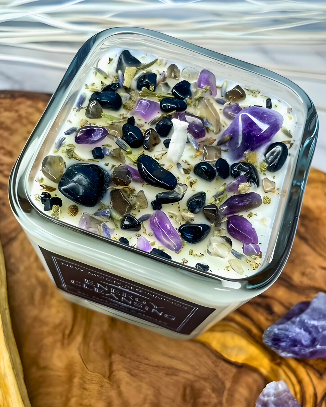 Candle with embedded stones on a wooden surface
