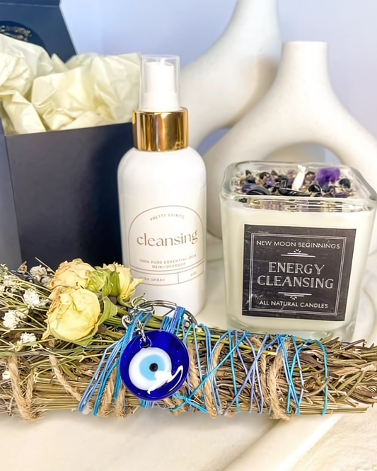 Cleansing product, candle, and decorative items on a white surface