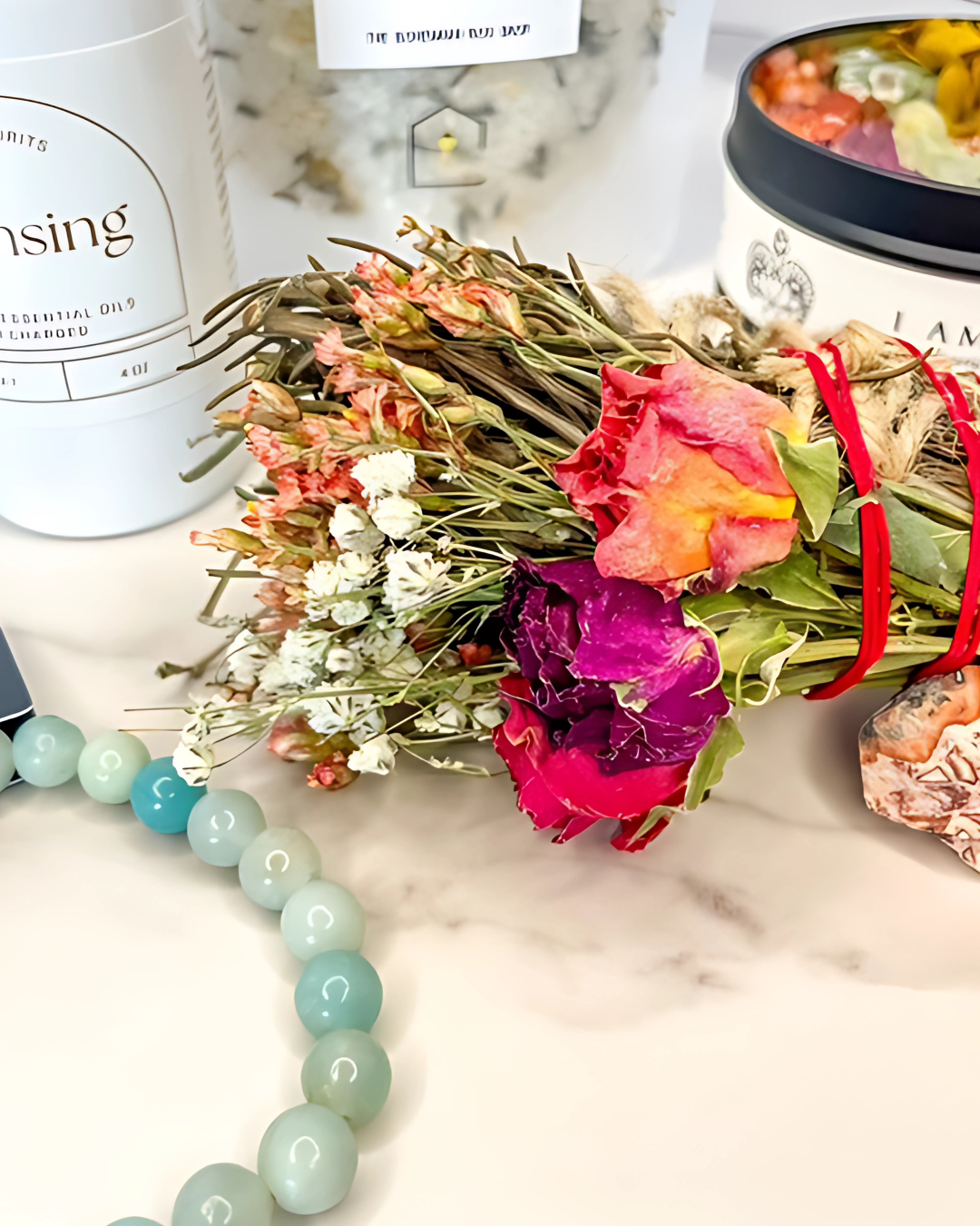 Bouquet of dried flowers with a bracelet on a marble surface