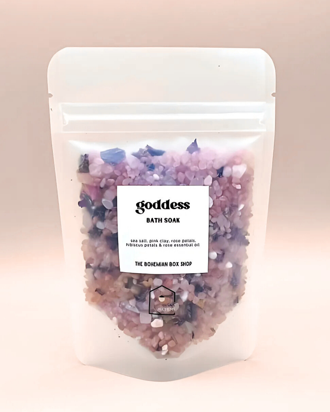 Bath soaks with visible crystals in a clear packaging on a pink background