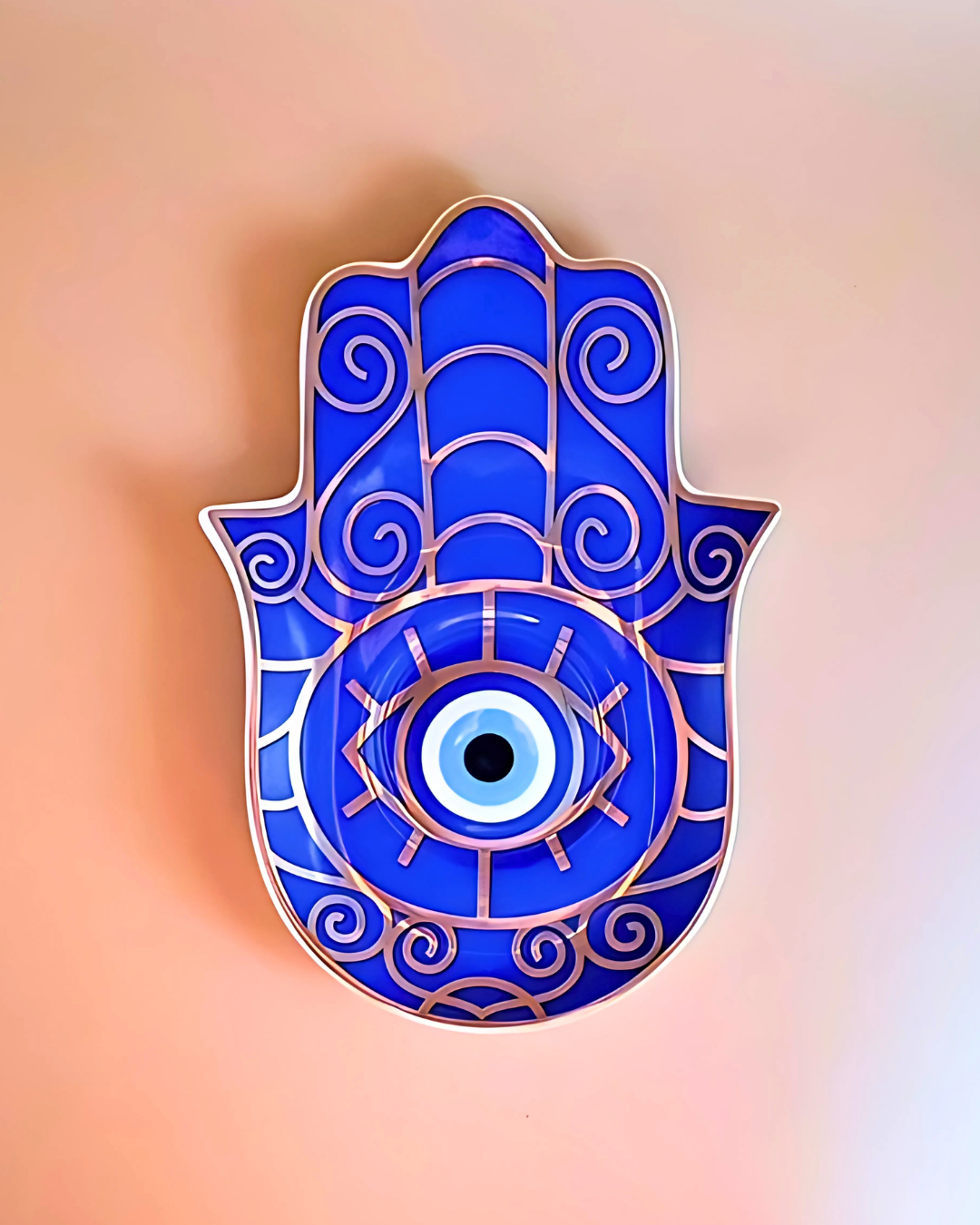 Blue Hamsa hand with an eye design on a gradient background