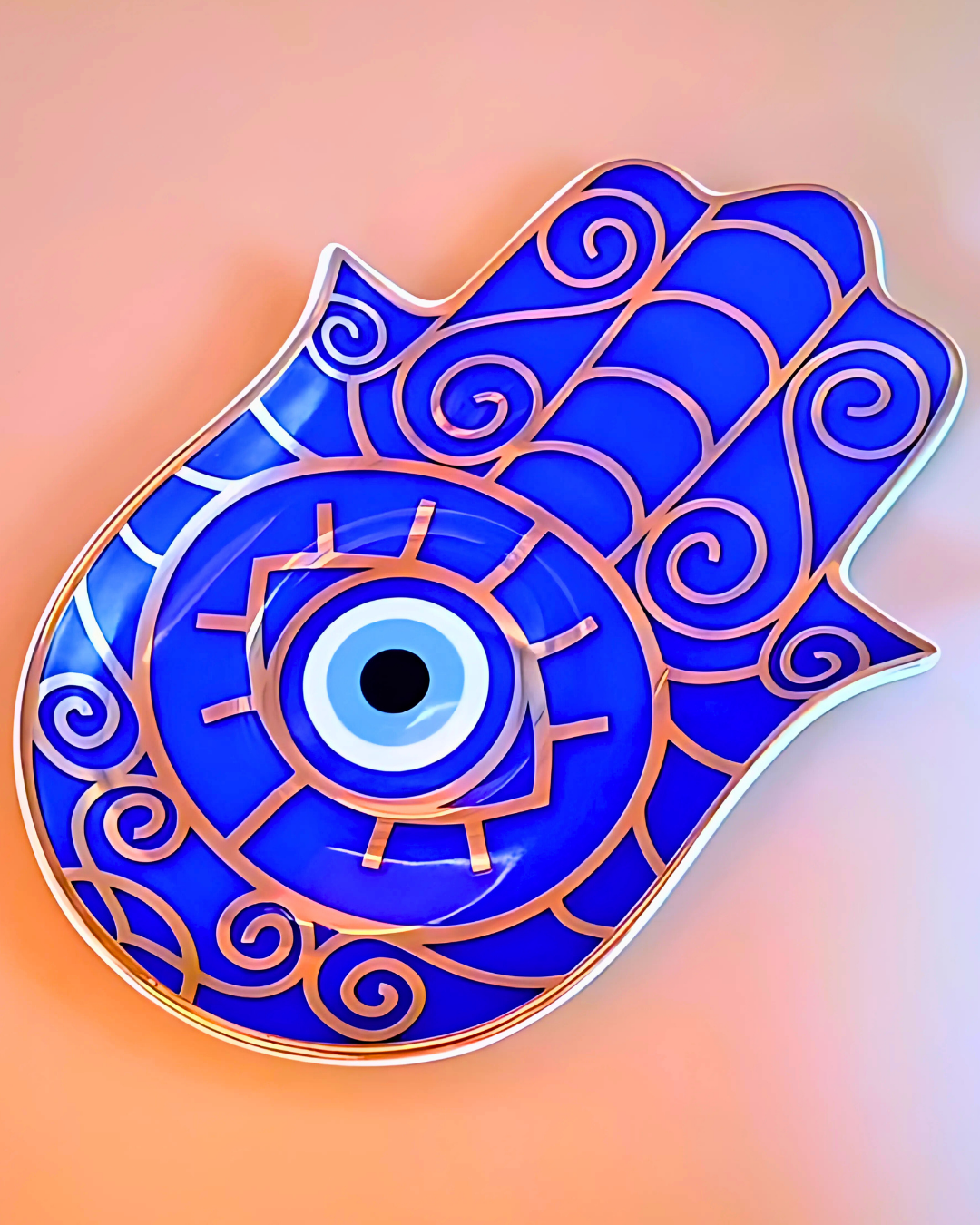 Decorative blue Hamsa hand with intricate patterns on a gradient background